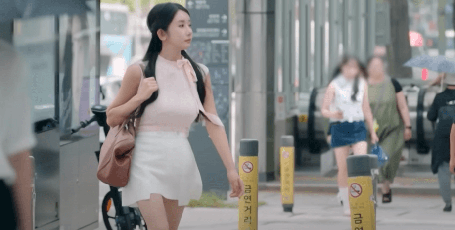 Женщина из Южной Кореи идет по улице в Сеуле после многочисленных пластических операций